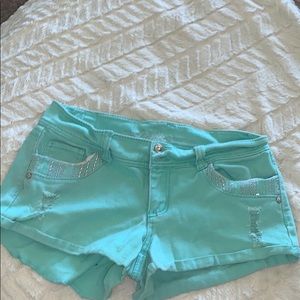 Distressed vanity mint denim shorts